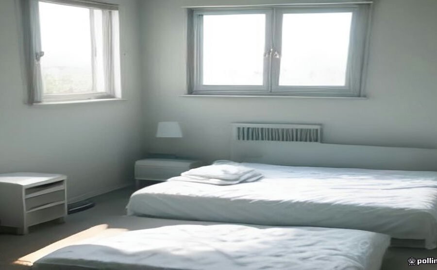 Spray bottle and baking soda on a mattress being cleaned near a sunny window